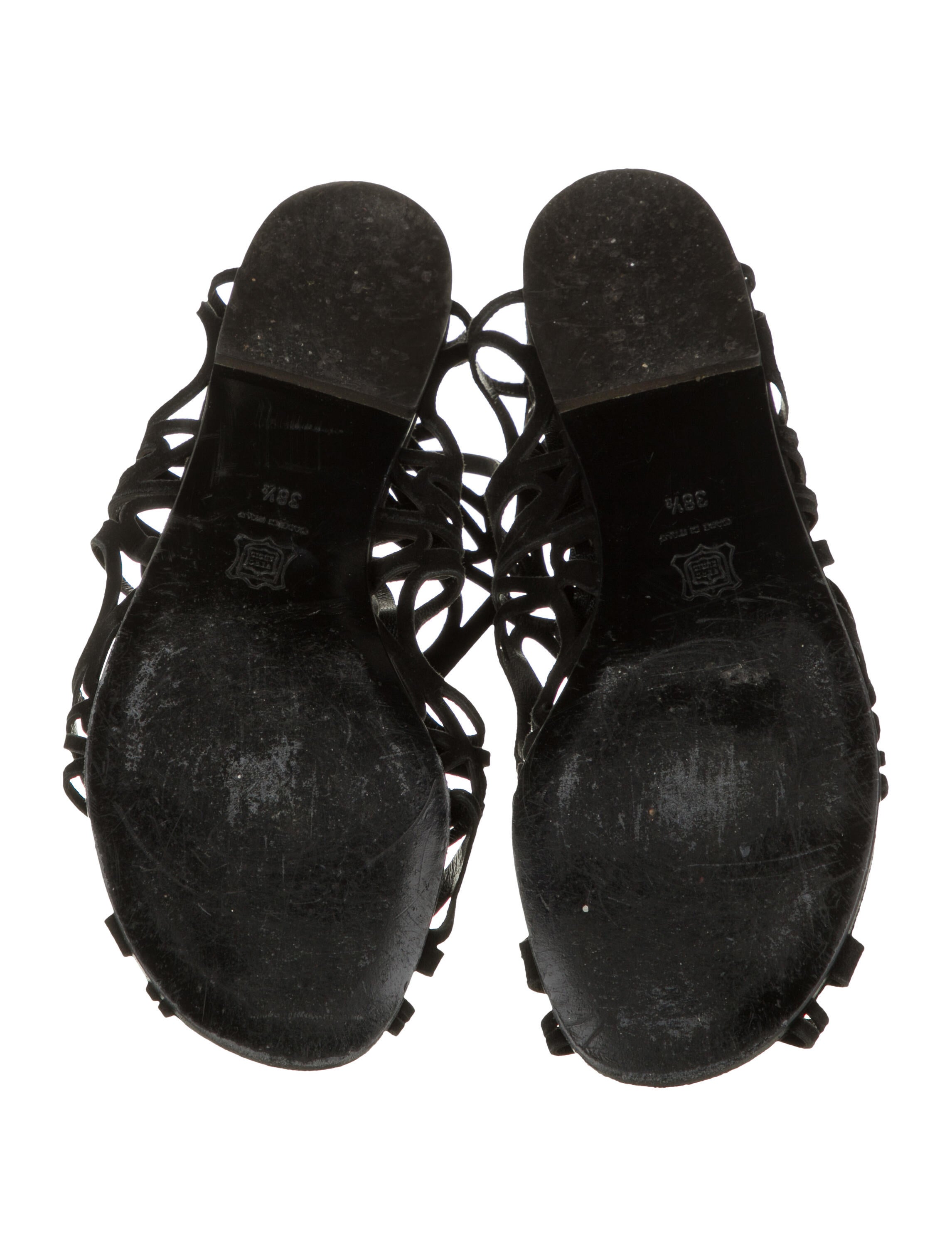 Black suede Stuart Weitzman cage sandals with stacked heels and zip closures at counters 