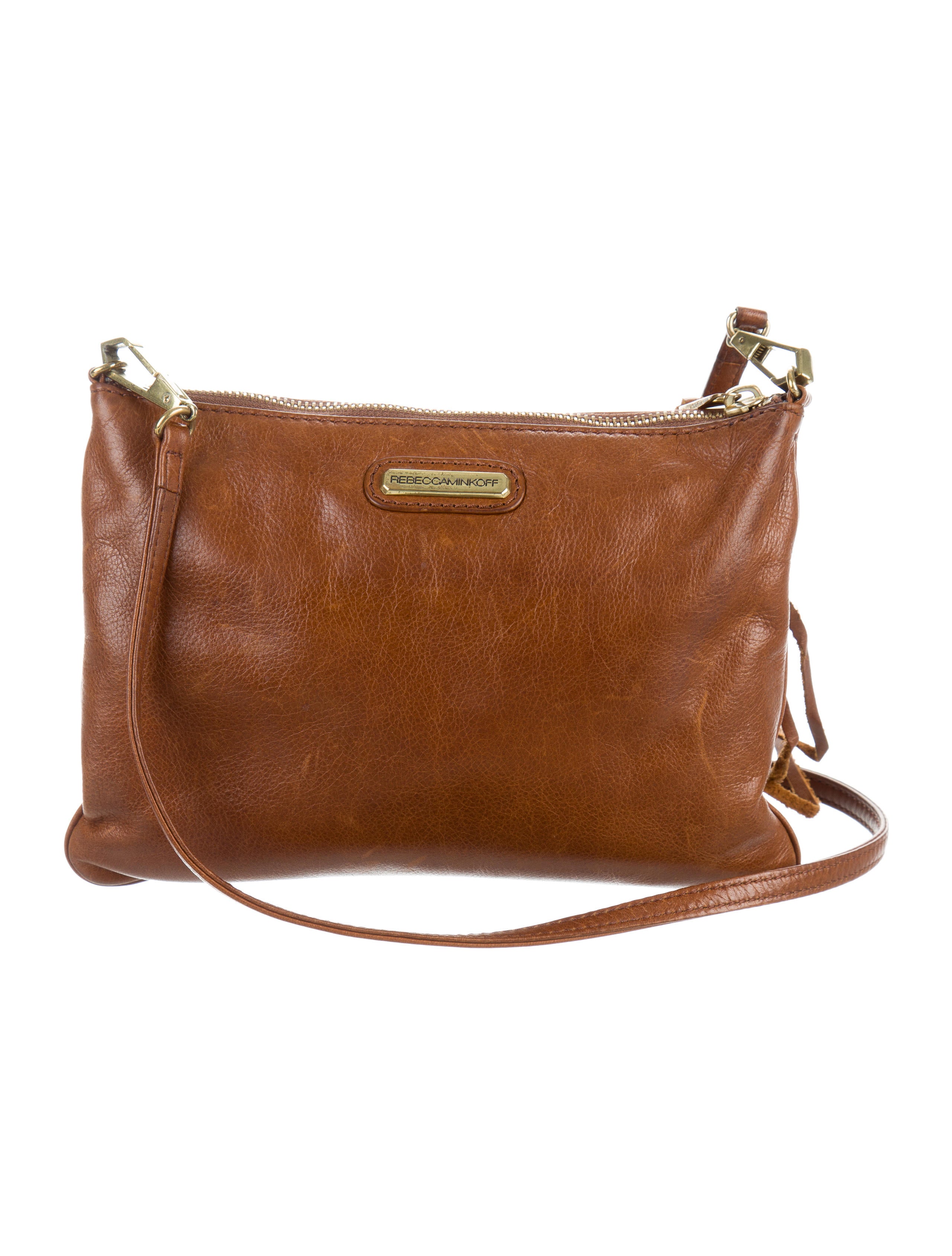 Departments More Details Tory Burch Tilda Printed Nylon Crossbody Bag Details Tory Burch nylon crossbody bag in mixed flower and plant print. Removable top handle. Removable shoulder strap. Flap top with magnetic closure on ornamental buckle. Exterior, zip compartment under flap.